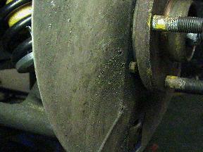 Front brake disc splash shield hidden fixing